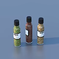 Three Spice Bottles With Green Brown Yellow Spices Black Caps Labels And Gray Background
