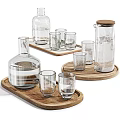 Transparent Glass Cups And Carafes Of Different Sizes On Wooden Trays For Drinking
