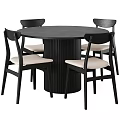 Round Black Dining Table with Ribbed Base and Four Modern Black Chairs with Beige Seats