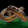 Intricate Metal Sculpture Featuring Intertwined Perforated Rings And Green Reflective Base