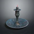 Elegant Bronze Candlestick With Lit Candle And Ornate Round Base Design