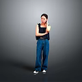 Stylish Woman In Black Top And Blue Jeans With Crossed Arms Standing Against Gray Background