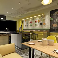 Modern Restaurant Interior With Yellow Seats Open Bar And Black White Checkered Walls Menu Screens