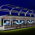 Modern Station With Illuminated White Roof Structure And Blue Billboards At Night