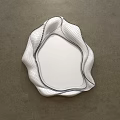 Irregular Curved Edge Mirror With Metallic Finish Reflecting Bedroom Interior On Gray Wall