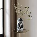 Black and White Patterned Vase with Green Leafy Branches on Gold Metal Frame Glass Table