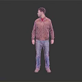 Man Wearing Red Jacket and Blue Jeans Standing Against Gray Background