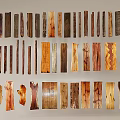 Stone Wood Wooden Pieces Displayed On Wall With Various Shapes Colors Arranged In Three Rows