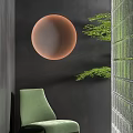 Green Leisure Chair With Orange Round Decor Dark Wall Green Plants And Glass Partition