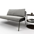 Gray Sofa With Fabric Cushions Metal Frame And Black Three Tier Side Table With Books