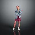 A Woman In Gray Jacket And Pink Floral Skirt Standing On Dark Background With White Sneakers