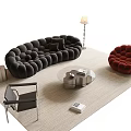 Modern Living Room With Black Tufted Sofa Round Coffee Table Red Armchair And Rug