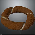 Golden Brown Ring Shaped Pastry With Textured Surface And White Cream Filling