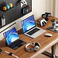 Two Laptops On Wooden Desk With Headphones Mouse Game Controller And Desk Lamp