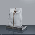Hand Carved Paper Bag Sculpture With Brown String Tag On Modern Design Book Gray Background