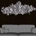 Cloud Shaped Chandelier Hanging Over Light Sofa In Living Room With Dark Wooden Wall