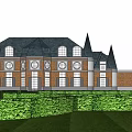 Castle Style Building With Red Brick Structure And Tall Spires Near Green Hedges