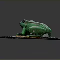 Green Reptile Sculpture On Gray Stone Paved Surface With Wooden Base