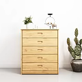 Natural Wooden Chest of Drawers Against White Wall with Potted Plants and Ornaments