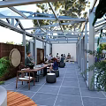 Glass Greenhouse Style Restaurant With Transparent Roof Dining Area And Indoor Plants