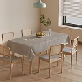 Simple Dining Table Set With Tablecloth Woven Back Chairs Plant Fruits And Wooden Floor