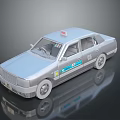 Detailed Silver Taxi Model with Red Roof Light and Blue Body Decals on Reflective Surface