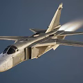 Military Fighter Jet Flying At High Speed With Visible Jet Trail In Clear Blue Sky