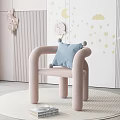 Pink Single Sofa With Blue Cushion On Round Rug And Star Moon Cloud Wall Decor