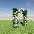 Decorative Archway Adorned With White Flowers And Green Plants On Green Grass Under Blue Sky