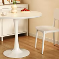 White Round Dining Table with Chairs Vase Flowers Bottles Strawberries Coffee Cup and Book