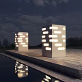 Modern White Column Outdoor Lights With Perforated Design Illuminating Nighttime Water Reflection And Stone Pavement