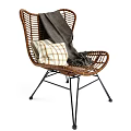 Wicker Lounge Chair With Plaid Pillow And Linen Blanket On Black Metal Frame