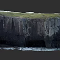 Microtopography of Coastal Cliff With Green Grass Black Rock and Ocean Waves