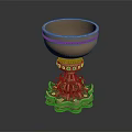 Ornate Golden Cup With Green Gemstone Embellishments And Intricate Pedestal Base