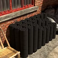 Black Cylindrical Blocks Stacked By Red Brick Wall With Bamboo Chair And Sacks