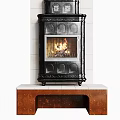 Ornate Black Fireplace With Burning Flames Against White Tiled Wall And Brown Base