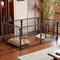Black Metal Pet Cage with Soft Mat and Toys in Living Room with Wooden Floor