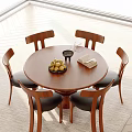 Round Wooden Dining Table Set With Four Black Cushioned Chairs Fruit Bowl And Open Book