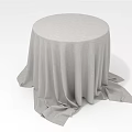 Round Table Covered With Light Gray Tablecloth Featuring Soft Draped Fabric And Natural Folds