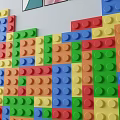 Colorful LEGO Brick Decorative Wall With Framed Artworks And Potted Plants