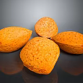 Five Fresh Orange Speckled Almonds Placed on Black Reflective Surface
