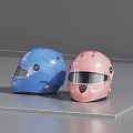 Two Glossy Blue And Pink Motorcycle Racing Helmets With Visors On Gray Surface