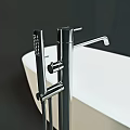 Modern Bathroom Faucet Design With White Freestanding Bathtub And Metal Finish On Dark Background