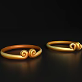 Golden Decorative Ornament Set Featuring Two Rings with Curled Designs