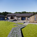 Rustic Stone House Exterior With Slate Roof And Stone Path Through Green Grassland