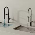 Two Modern Kitchen Faucets Black Curved And Silver Pull Down With Water Flowing 3d model