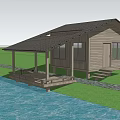 Wooden House With Roofed Deck Steps Waterfront And Green Grass Area