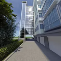 Tall Modern Residential Building with Glass Facade and Green Landscaping Along Driveway and Garage Entrances