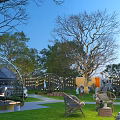 Scenic Park Landscape With Tall Trees Green Lawn Circular Arches Outdoor Seating And String Lights