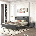 Modern Black Leather Double Bed With Floral Bedspread Nightstand And Decorative Paintings In Bedroom